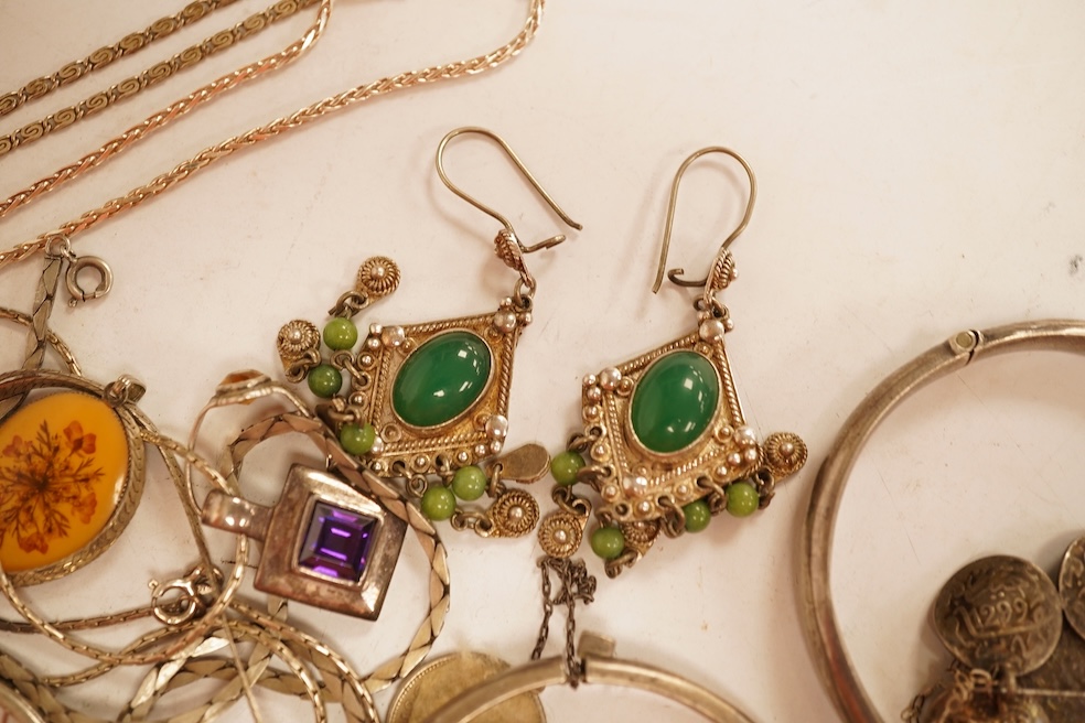 A small group of silver and white metal jewellery including Siamese enamelled bangle, silver chain, drop earrings, Persian coin brooch, etc.